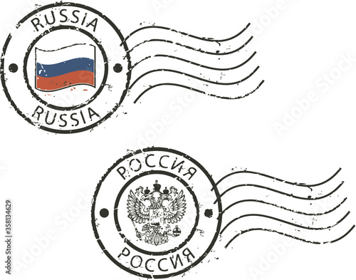 Two postal grunge stamps 'Russia' with the flag and two-headed eagle. Latin and cyrillic inscription.