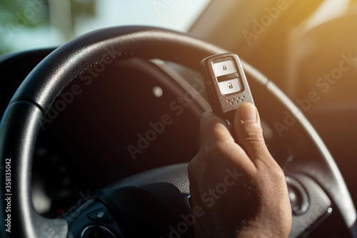 Close up of a car key and remote control in vehicle interior. Transport travel concept.. © Chanakon