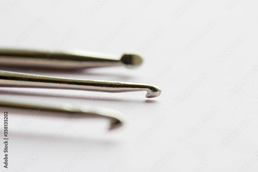 Fototapeta premium Set of crochet hooks close up. Metal tools for handmade
