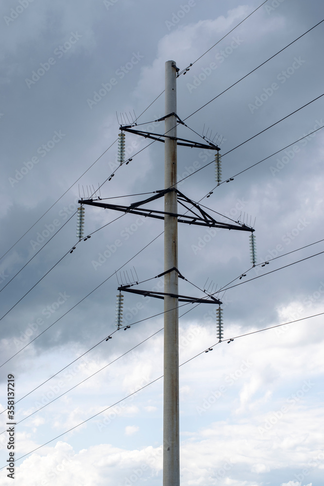 Pillar and power lines against a cloudy sky Pillar and power lines against a cloudy sky