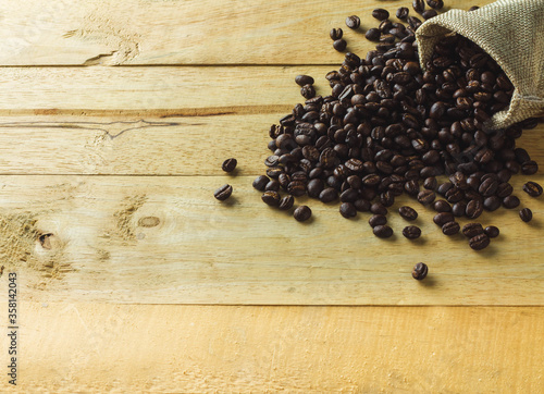 Coffee Beans in a Bag on wooden background.