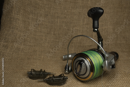 Fishing, carp reel with fishing linel on the background of burlap . Burlap photo