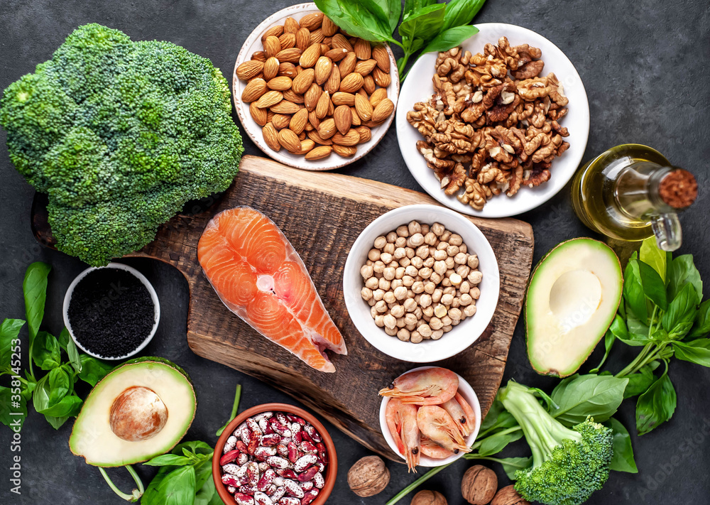 Omega 3 food sources on stone background. Foods high in fatty acids, including seafood, vegetables, nuts and seeds. Omega 3 food sources on stone background. Foods high in fatty acids, including seafood, vegetables, nuts and seeds.