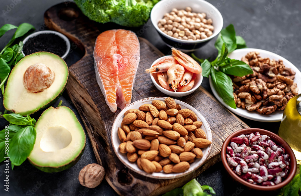 Omega 3 food sources on stone background. Foods high in fatty acids, including seafood, vegetables, nuts and seeds. Omega 3 food sources on stone background. Foods high in fatty acids, including seafood, vegetables, nuts and seeds.