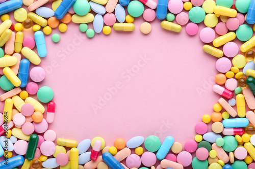 Colorful pills on pink background