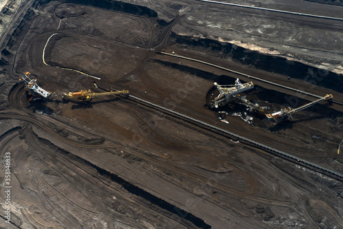 Aerial shoot of quarry with heavy bucket wheel excavators mining a coal. Heavy industry concept.