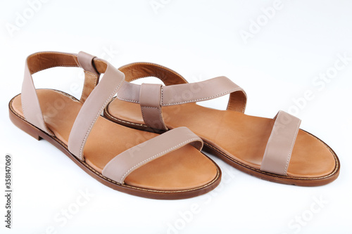 Female beige sandals isolated on white background