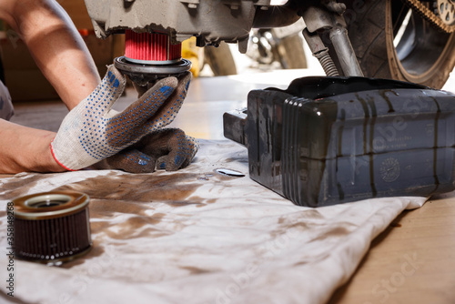 Fotografie The process of draining oil from a motorcycle engine