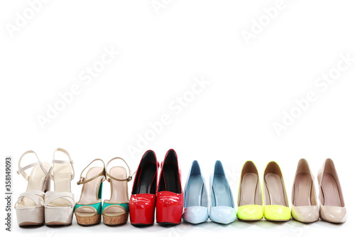 Different high heel shoes on white background