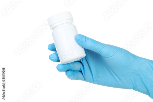 Doctor hand in glove holding medicine bottle on white background