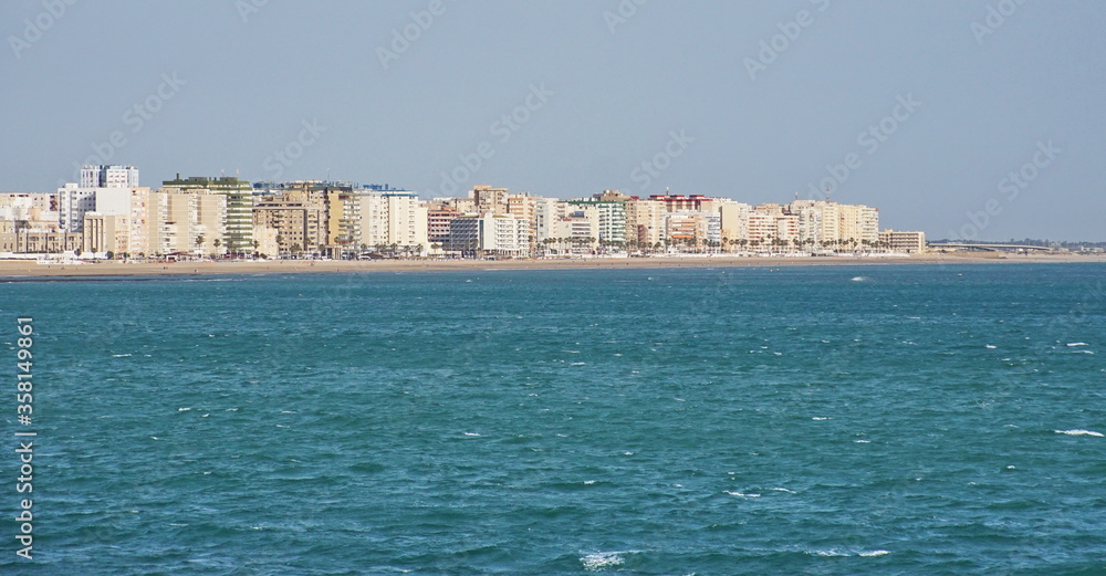 Cityscape of Cadiz town in southern Spain. Blue sky and sea.