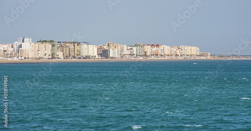 Cityscape of Cadiz town in southern Spain. Blue sky and sea.