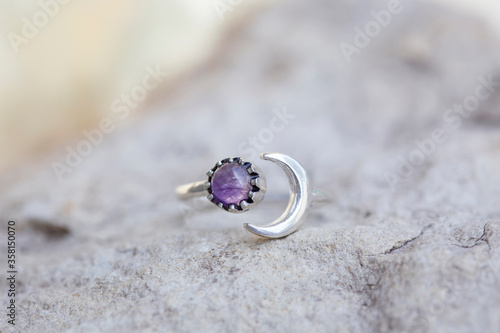 White metal silver ornamental ring with amethyste mineral stone photo