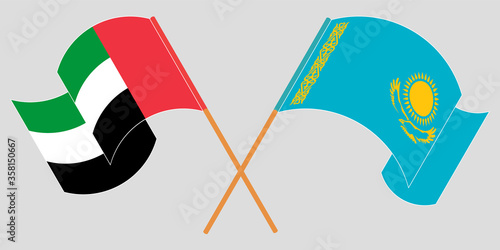 Crossed and waving flags of Kazakhstan and the United Arab Emirates