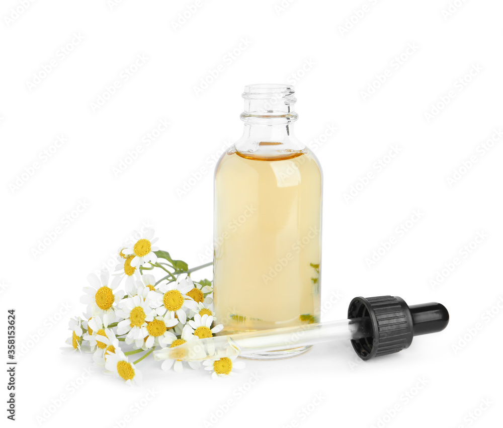Bottle of essential oil with pipette and fresh chamomiles isolated on white Bottle of essential oil with pipette and fresh chamomiles isolated on white
