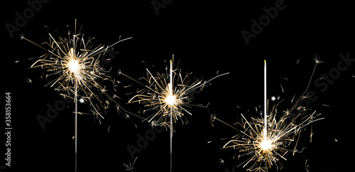 Set of burning sparklers on black background. Banner design