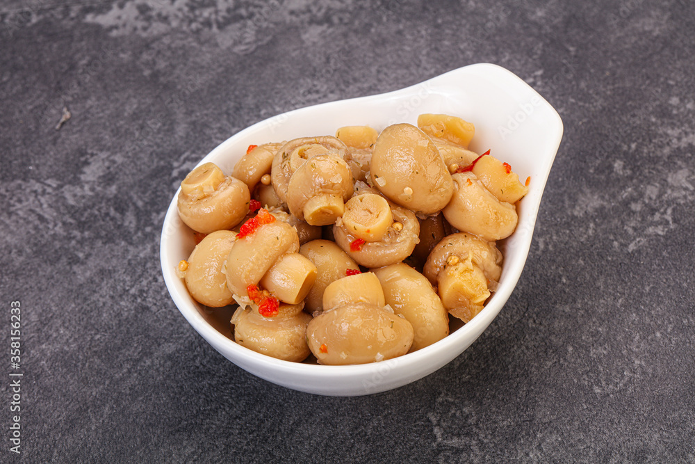 Pickled champignons in the bowl Pickled champignons in the bowl