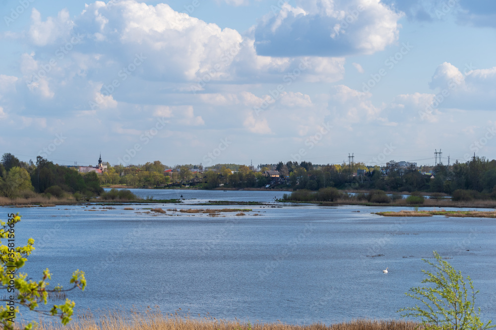 Fototapeta premium View to Daugava river on sunny spring day with the Kekava town on the opposite bank