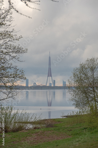 View to the foggy skyline of Riga and Daugava river on cloudy spring evening  © Ilga