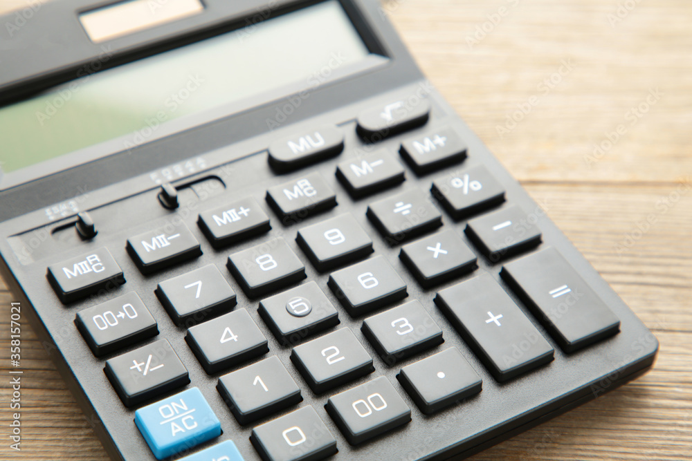 Calculator on grey wooden background, macro foto Calculator on grey wooden background, macro foto