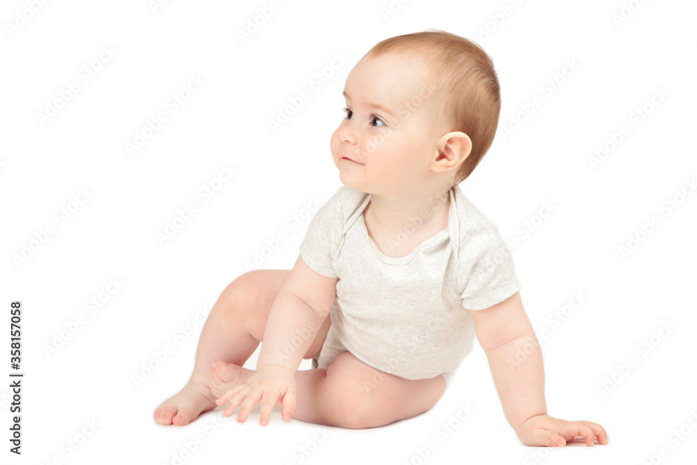 Happy child is sitting on floor isolated on white background Happy child is sitting on floor isolated on white background