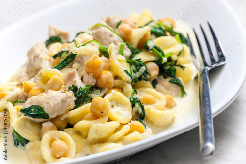 pasta orecchiette with chicken meat, chick peas and spinach