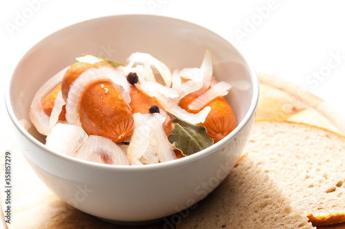 homemade pickled sausages with onion and bread photo