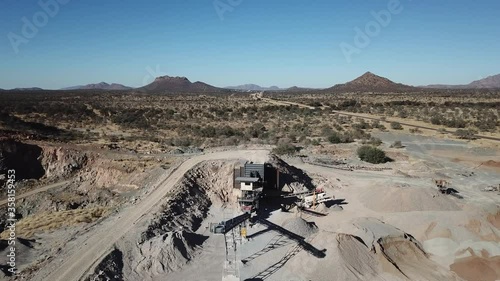 4K aerial drone video of African savanna hills, stone quarry near granite boulders range at B1 highway south of Windhoek in central highland Khomas Hochland of Namibia, southern Africa photo