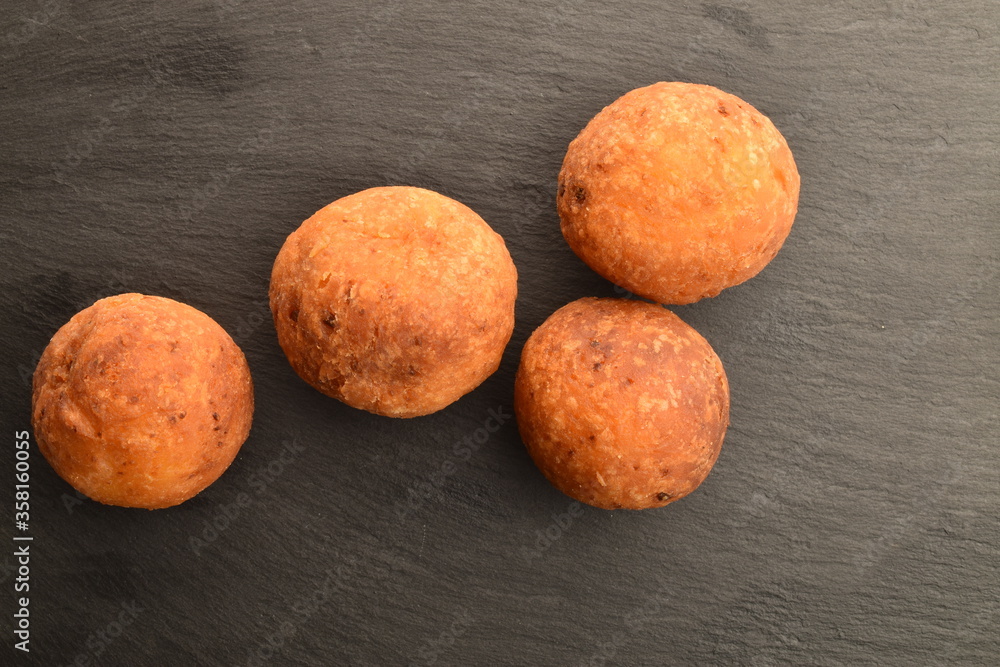 Fresh aromatic, cheese donuts, close-up, on a slate board. Fresh aromatic, cheese donuts, close-up, on a slate board.