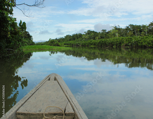 Boat swims across a lake in jungle in peru