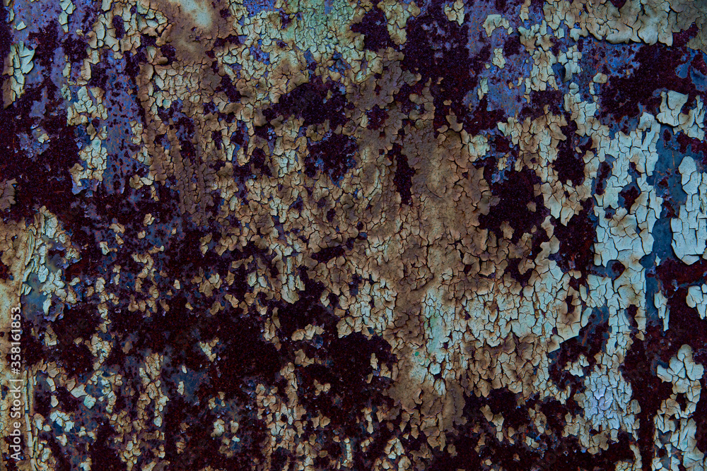 Textured dark multicoloured painted bubbly cracked peeling rusty aged metal background. Textured dark multicoloured painted bubbly cracked peeling rusty aged metal background.