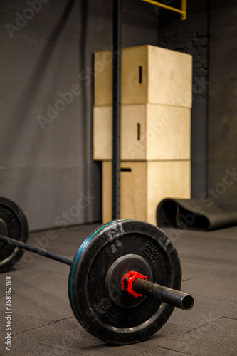 Fitness equipment for workout in Gym. Barbell with weights plate on floor. Fitness concept.
