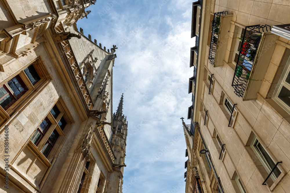 Historical buildings in Rouen, France. Low angle view against blue cloudy sky.