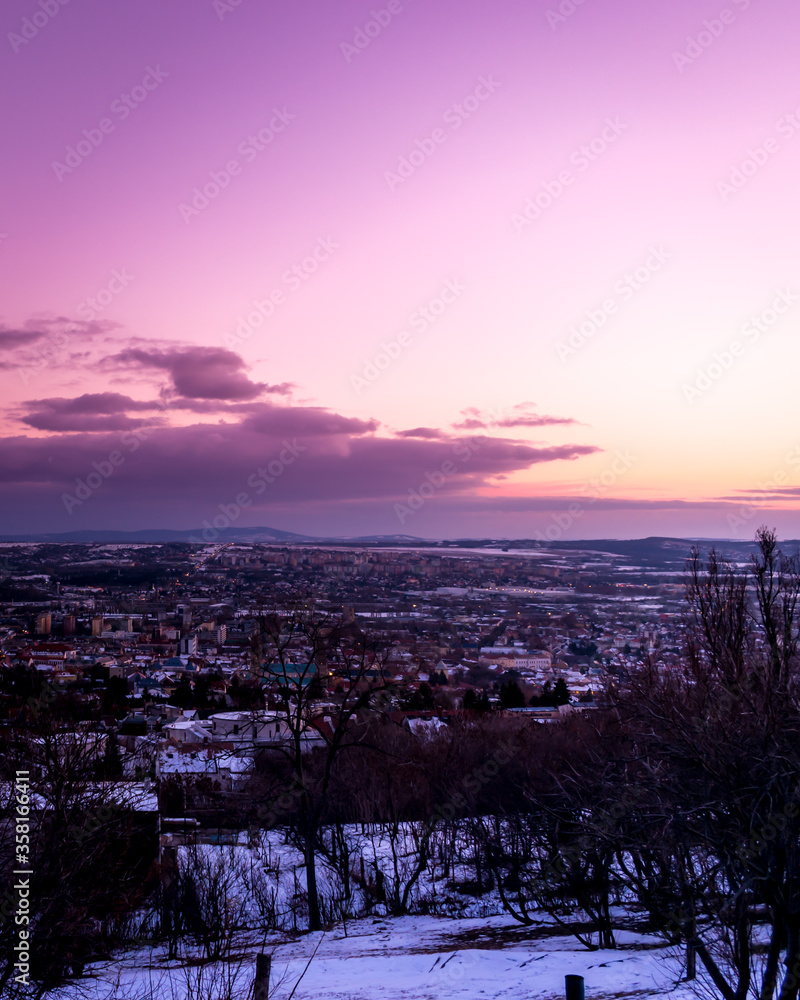 The city of Pecs at a purple sunset in Hungary, Europe