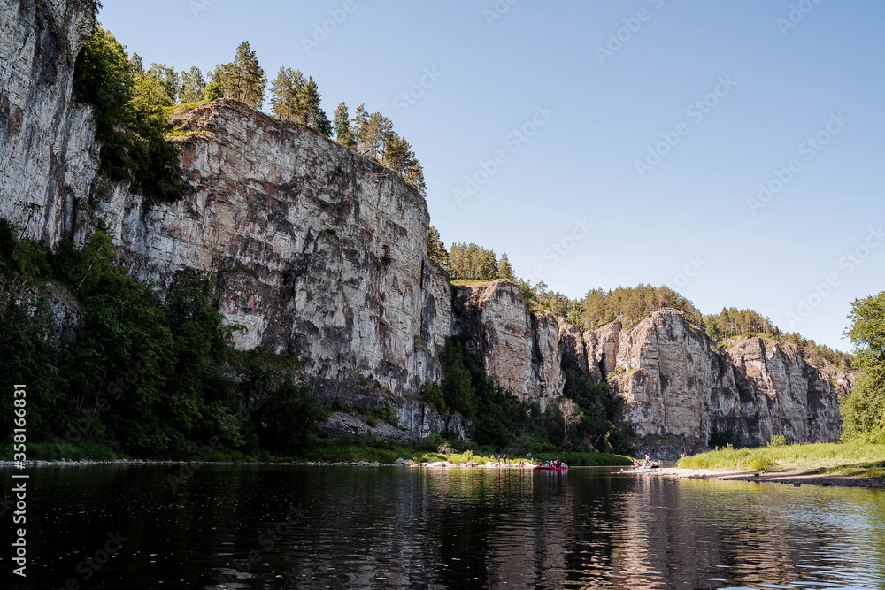 summer day on the river with rocky banks, blue sky, mountains, forest, landscape, river AI