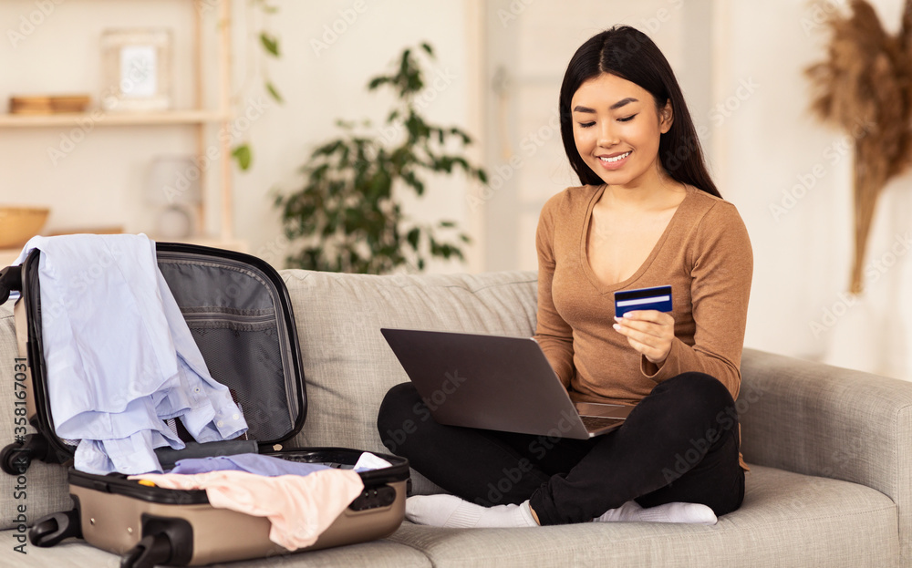 Girl With Laptop And Credit Card Booking Tickets At Home Girl With Laptop And Credit Card Booking Tickets At Home