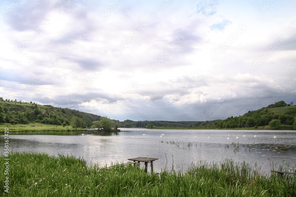 Beautiful river in a pretty area in Siberia. Landscape in Canada with a cold lake. Stock photo background. Beautiful river in a pretty area in Siberia. Landscape in Canada with a cold lake. Stock photo background.