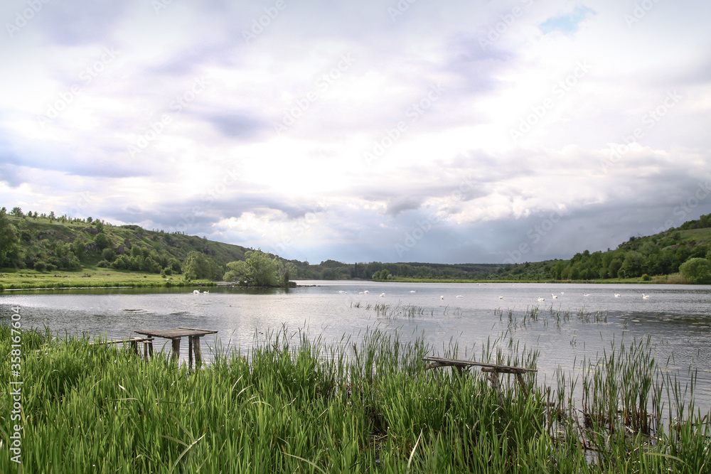 Beautiful river in a pretty area in Siberia. Landscape in Canada with a cold lake. Stock photo background. Beautiful river in a pretty area in Siberia. Landscape in Canada with a cold lake. Stock photo background.