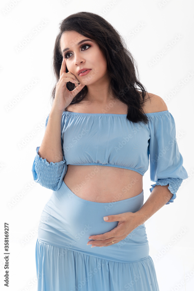 Happy smiling pregnant woman touching her belly isolated on white background. Pregnancy concept studio portrait Mother expecting baby. Baby tea. Happy smiling pregnant woman touching her belly isolated on white background. Pregnancy concept studio portrait Mother expecting baby. Baby tea.