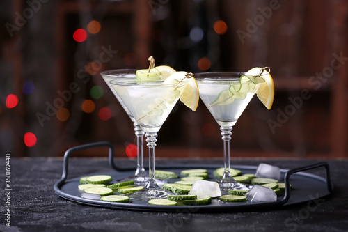 Glasses of tasty cucumber martini on table in bar