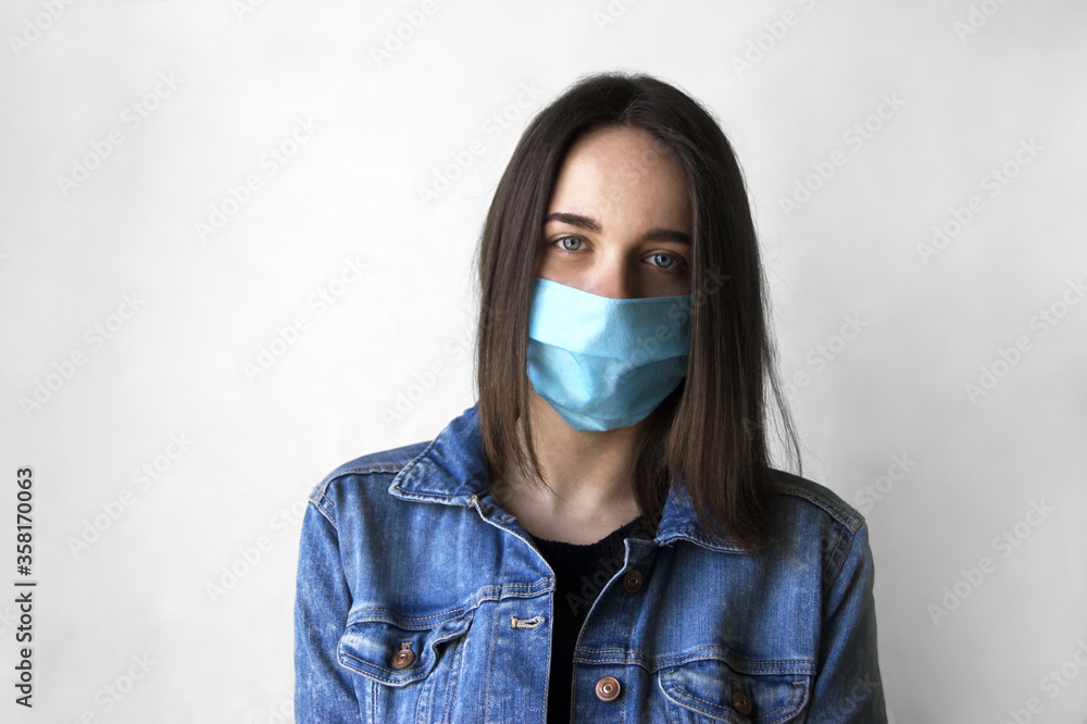 The image face of a young woman wearing a medicine mask. The image face of a young woman wearing a medicine mask.