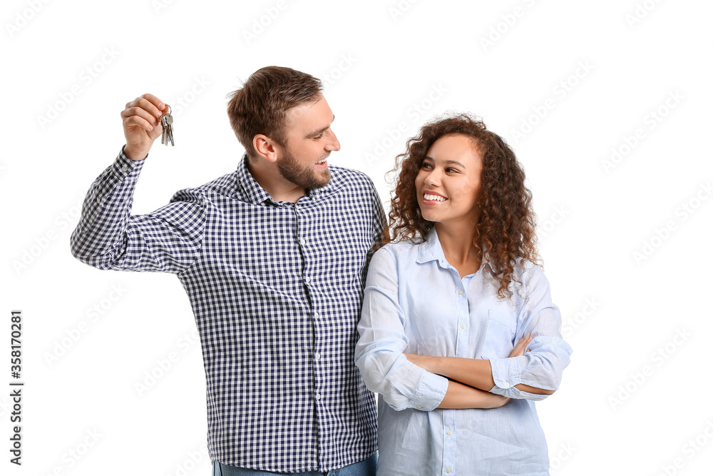 Happy young couple with key on white background Happy young couple with key on white background