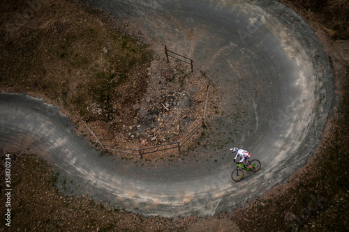 WINTERBERG, GERMANY. Aerial view of a mountain biker riding a 180 degree corner on a purpuse built MTB trail.