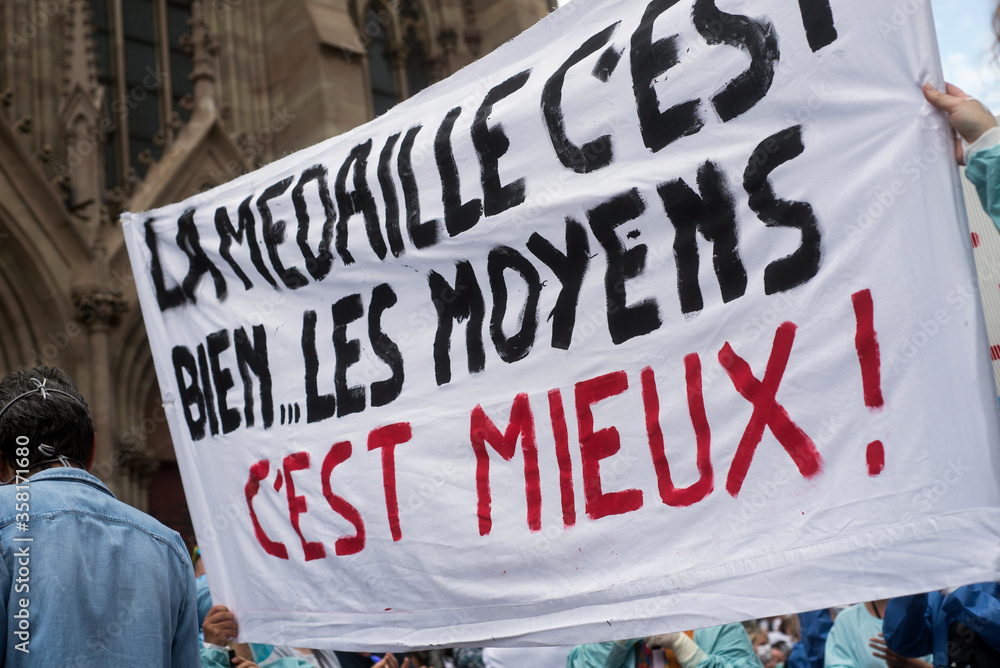 Fototapeta premium Mulhouse - France - 16 june 2020 - people protesting with a medical masks in the street to have more resources for hospitals and a salary increase