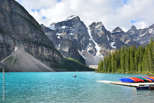 The scenery around Moraine Lake with colorful kayaks from boat house