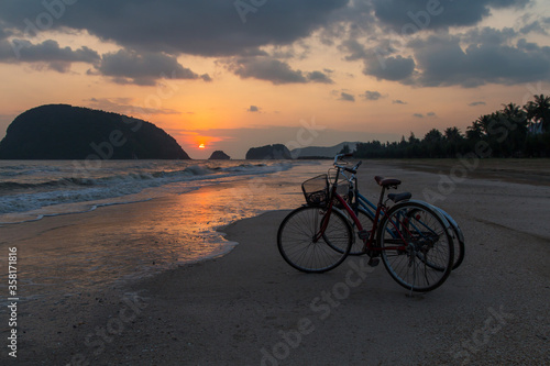 silhouette of bicycle at beach, bicycles on beach sunset or sunrise © saelim