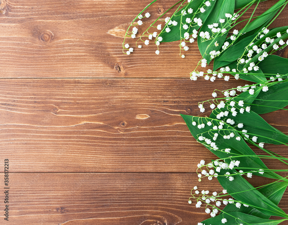 White lilies of the valley on a wooden background. copyspace