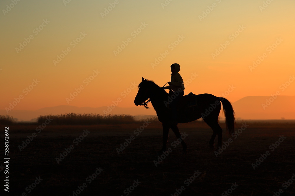 Silhouette view of a horseman at sunset. Cappadocia, Turkey