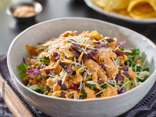 crunchy mexican salad with multi color tortilla strips and chipotle ranch dressing