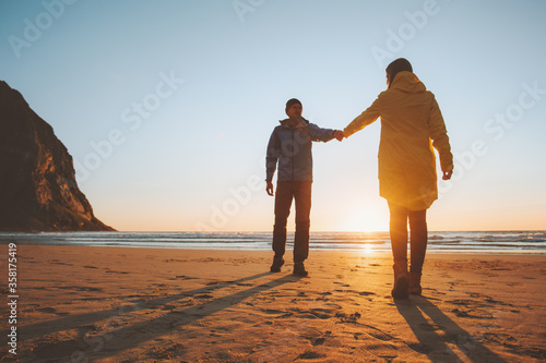 Romantic couple in love holding hands walking on beach man and woman traveling together lifestyle vacation trip outdoor